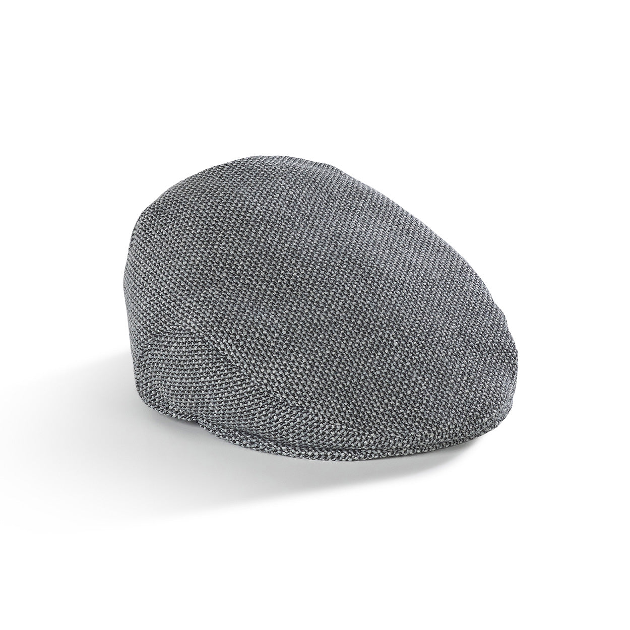 Side view of The Flat Cap Bit of Blue, a structured wool flat cap with a classic fit. Zijkant van de blauwe wollen platte pet met tijdloos design.