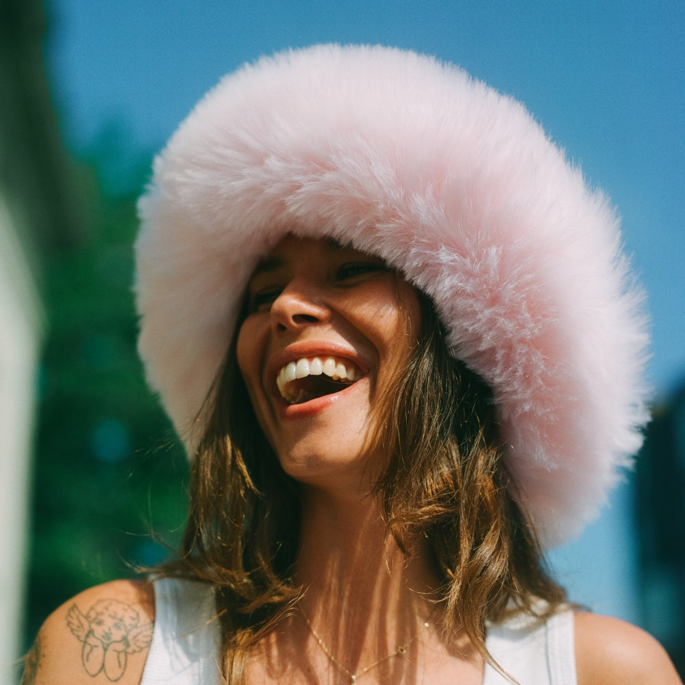 The Bucket Hat. Furry Bucket Hat. Faux Fur Bucket Hat. Fluffy Bucket Hat. Winter Bucket Hat. Brown Bucket Hat. Winter Bucket Hat. Winter Hat Styles. Fluffy Winter Hat Style. Winter Skiing hat styles. Pink Bucket hat. Pink fun furry hat. Pink Fur Hat.