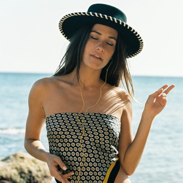 The Bullfighter Bonita hat. The Bullfighter Bonita Black Hat with White Stitching. Unique Hat. Statement Hat. Stylish Hat. Model with Hat. Woman with Hat.